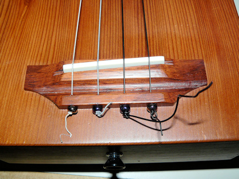 Cigar box repaired, new Tusq saddle